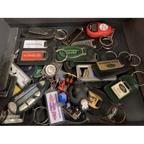 223 - A LARGE COLLECTION OF VARIOUS KEY RINGS AND TWO BODY BUILDING BOOKS