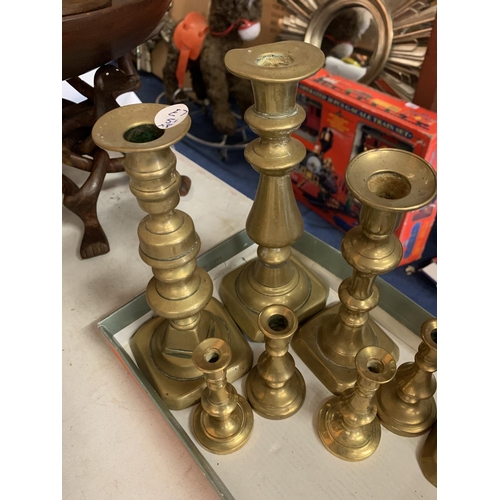 247 - EIGHT VARIOUS SIZED BRASS CANDLESTICKS