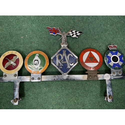 10A - SIX VINTAGE CAR BADGES ON A CHROME FRAME TO INCLUDE WAGBI, RAC, INSTITUTE OF ADVANCED MOTORISTS ETC