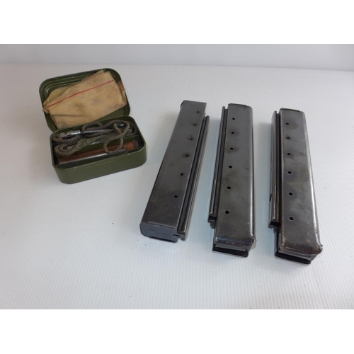 323 - THREE MACHINE GUN MAGAZINES AND A CASED GUN CLEANING KIT