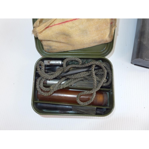 323 - THREE MACHINE GUN MAGAZINES AND A CASED GUN CLEANING KIT