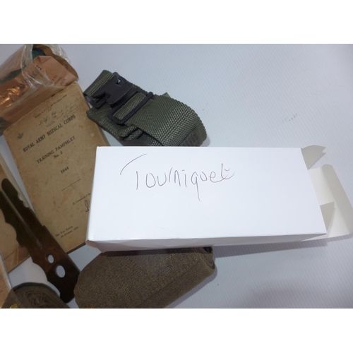 326 - A MEDICAL DECONTAMINATION KIT, BANDAGE, TWO PAIRS OF PUTTEES, BOOKLETS, WWII TOURNIQUET ETC