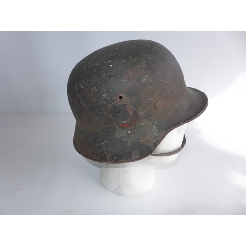 375 - A GERMAN WORLD WAR II HELMET, COMPLETE WIH INNER LINER AND CHIN STRAP. ACCORDING TO THE VENDOR THIS ... 