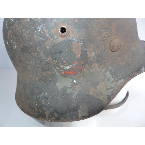 375 - A GERMAN WORLD WAR II HELMET, COMPLETE WIH INNER LINER AND CHIN STRAP. ACCORDING TO THE VENDOR THIS ... 