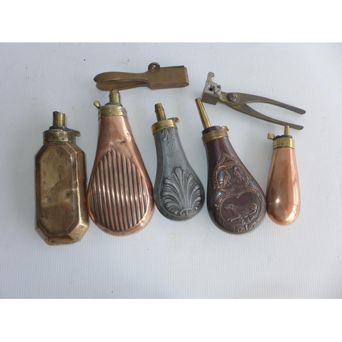 388 - FIVE COPPER AND BRASS POWDER FLASKS AND TWO BULLET MOULDS