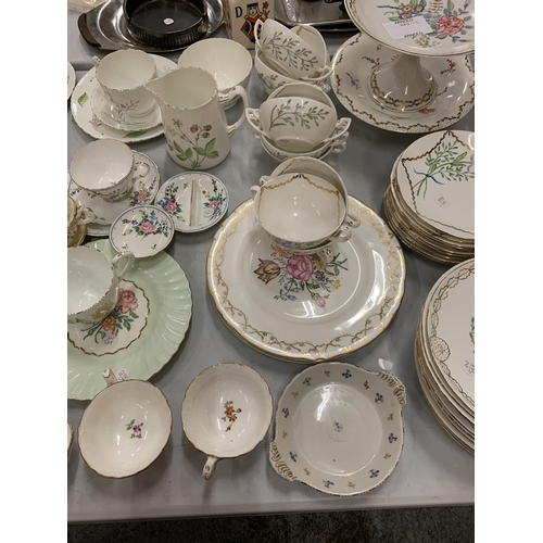 104 - AN EXTENSIVE COLLECTION OF FLORAL DECORATED TEA WARE INCLUDING CAKE STANDS