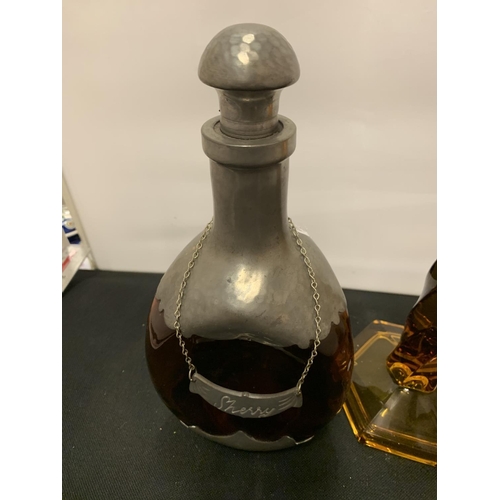 57 - A PEWTER AND GLASS SHERRY BOTTLE WITH STOPPER AND NAME CHAIN AND TWO AMBER COLOURED GLASS CANDLESTIC... 