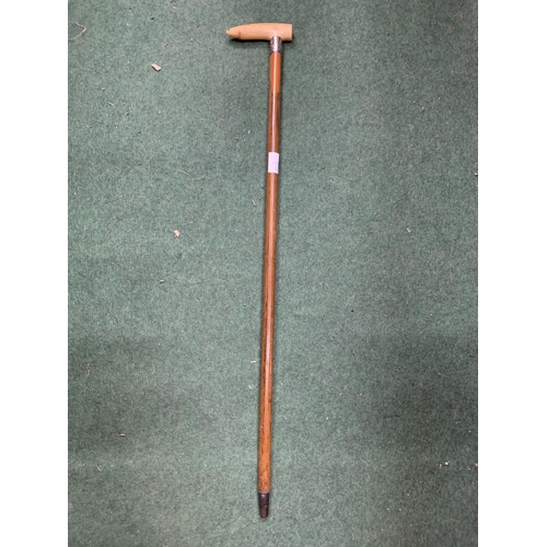 62 - A WALKING STICK WITH A BONE HANDLE AND A POSSIBLY SILVER FINIAL