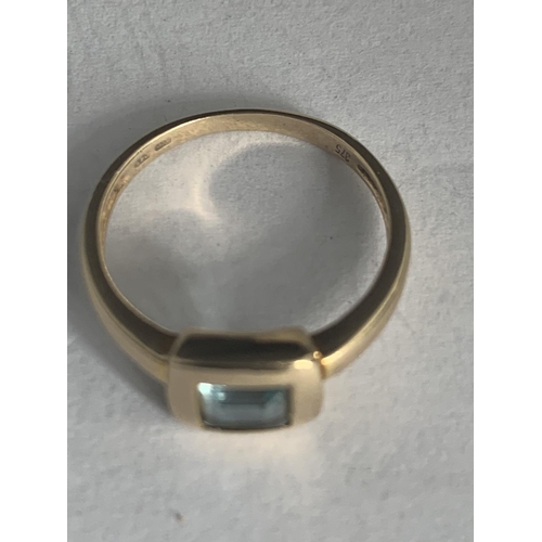 541 - A 9 CARAT GOLD RING WITH LIGHT BLUE STONE