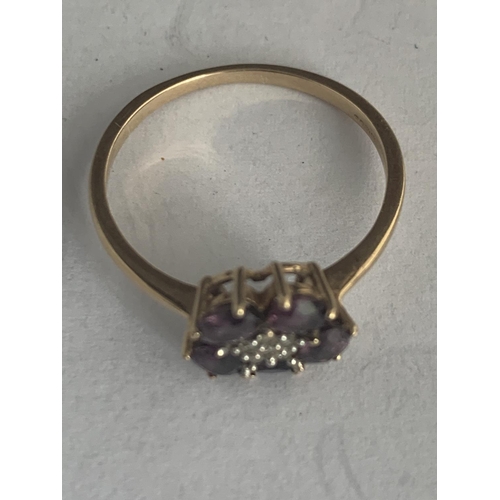 542 - A 9 CARAT GOLD RING WITH DIAMONDS AND FIVE LIGHT RED STONES