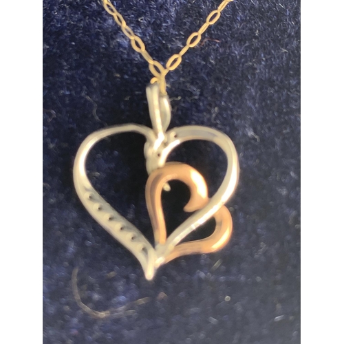 551 - A 9 CARAT GOLD NECKLACE WITH SILVER AND GOLD HEART PENDANT