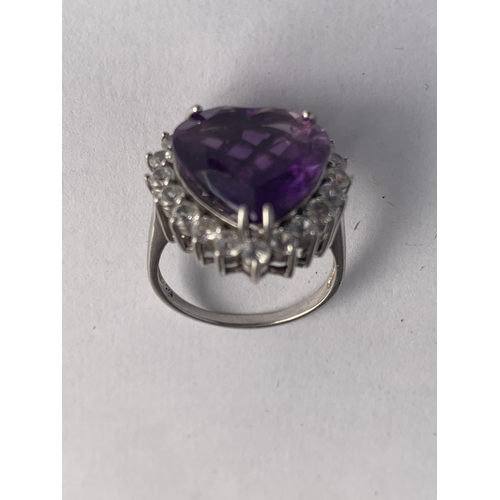 588 - A SILVER MARKED LARGE HEART SHAPED AMETHYST AND PASTE STONE CLUSTER RING SIZE R.5