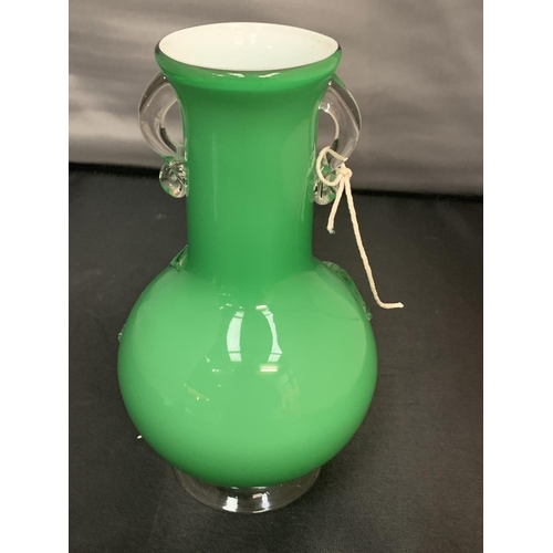 769 - A GREEN GLASS VASE WITH ORNATE FLOWER DESIGN