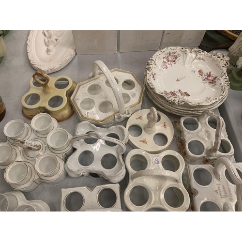 146 - A LARGE COLLECTION OF CERAMIC EGG CUPS AND HOLDERS