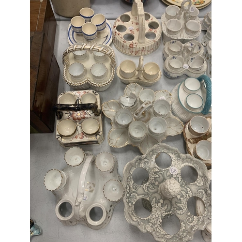 180 - A COLLECTION OF CERAMIC EGG CUPS AND HOLDERS