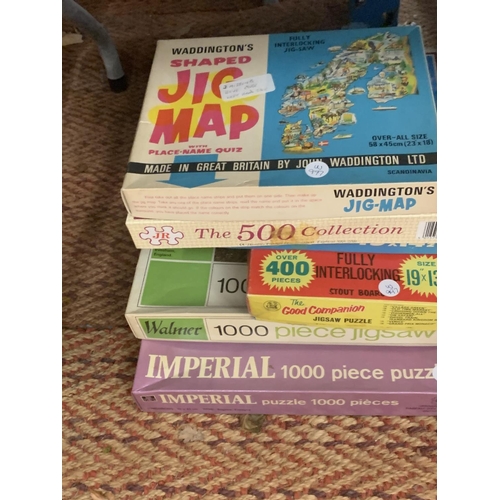 219 - A LARGE QUANTITY OF JIGSAWS AND VINTAGE BOARD GAMES