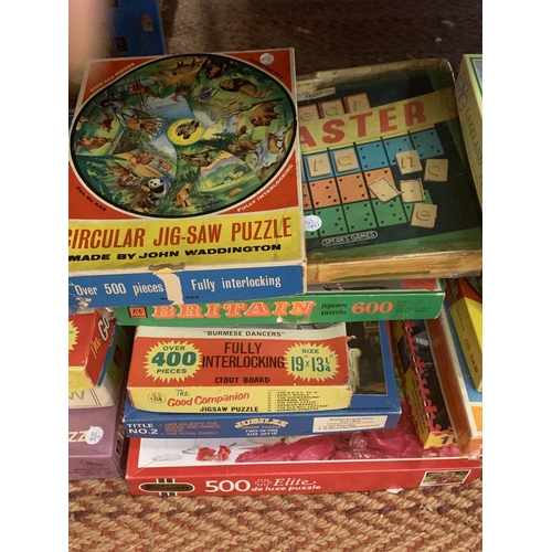 219 - A LARGE QUANTITY OF JIGSAWS AND VINTAGE BOARD GAMES