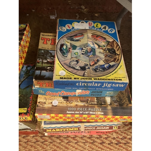 219 - A LARGE QUANTITY OF JIGSAWS AND VINTAGE BOARD GAMES