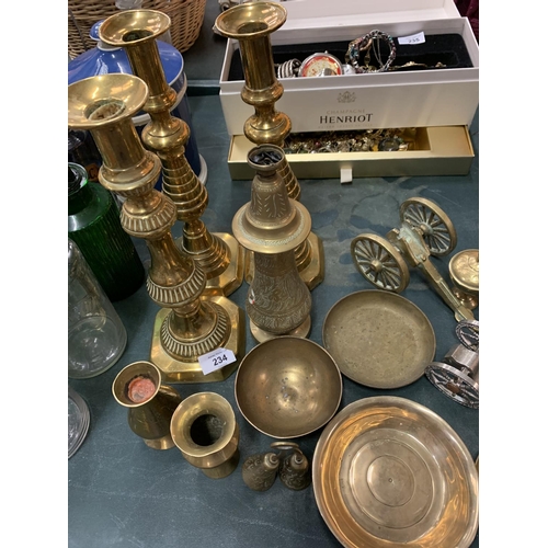 234 - AN ASSORTMENT OF BRASSWARE TO INCLUDE THREE LARGE CANDLE STICKS