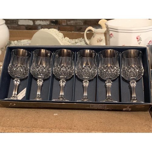 864 - A LARGE COLLECTION OF WINE GLASSES AND A DECANTER