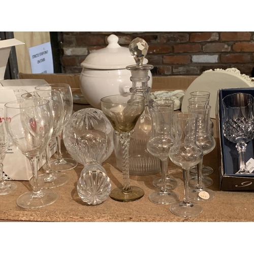 864 - A LARGE COLLECTION OF WINE GLASSES AND A DECANTER