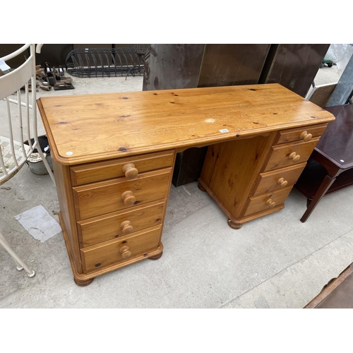 2048 - A PINE DESK WITH EIGHT DRAWERS