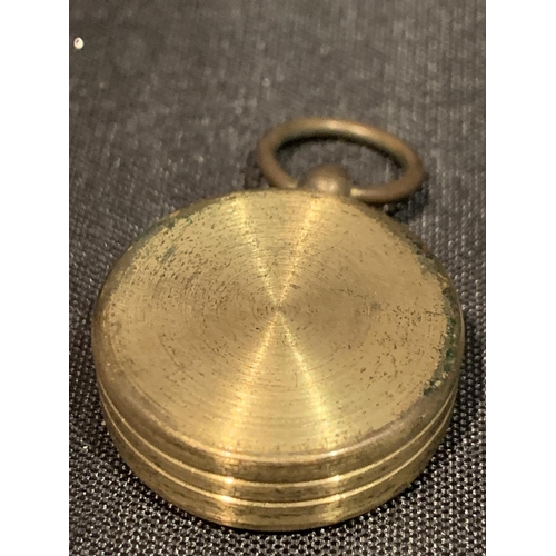 574 - A BRASS COMPASS IN A LEATHER CASE