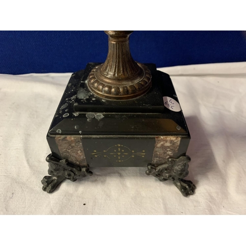 14 - AN ORNATE SPELTER FOUR CANDLESTICK MOUNTED ON A POLISHED SLATE BASE