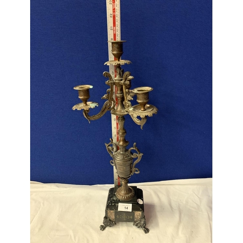 14 - AN ORNATE SPELTER FOUR CANDLESTICK MOUNTED ON A POLISHED SLATE BASE