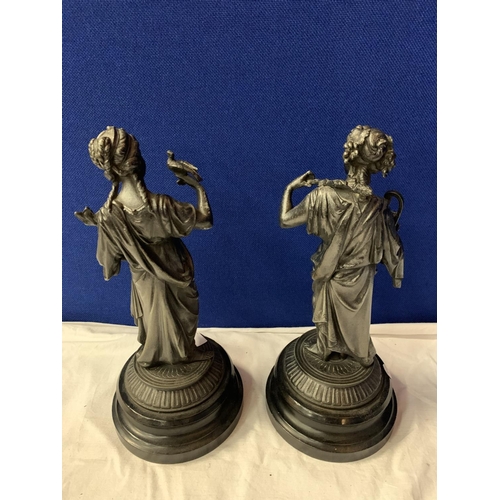 15 - A PAIR OF SPELTER FIGURINES ON POLISHED WOODEN BASES