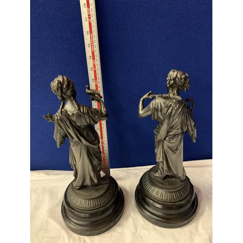 15 - A PAIR OF SPELTER FIGURINES ON POLISHED WOODEN BASES