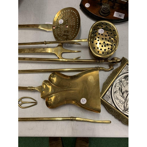 34 - A SELECTION OF BRASSWARE TO INCLUDE A TRIVET AND FIRESIDE SET