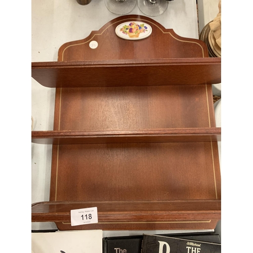 118 - A THREE TIER WOODEN WALL RACK WITH A SMALL CERAMIC PLAQUE EMBELLISHMENT