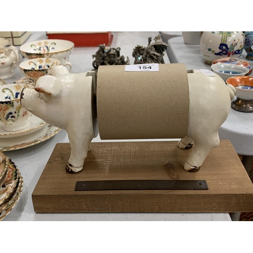 154 - A CAST METAL ROLL HOLDER IN THE GUISE OF A PIG