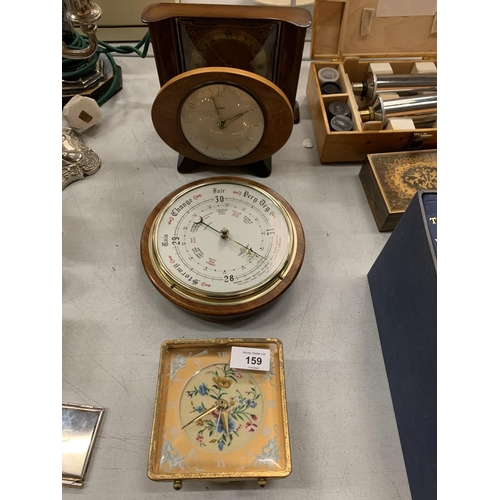 159 - THREE VINTAGE CLOCKS AND A BAROMETER TO INCLUDE A VINTAGE ALARM CLOCK WITH AN EMBROIDERED FACE