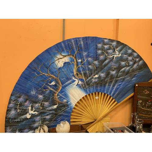 188 - A LARGE WOOD AND PAPER DECORATIVE ORIENTAL FAN