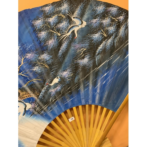 188 - A LARGE WOOD AND PAPER DECORATIVE ORIENTAL FAN