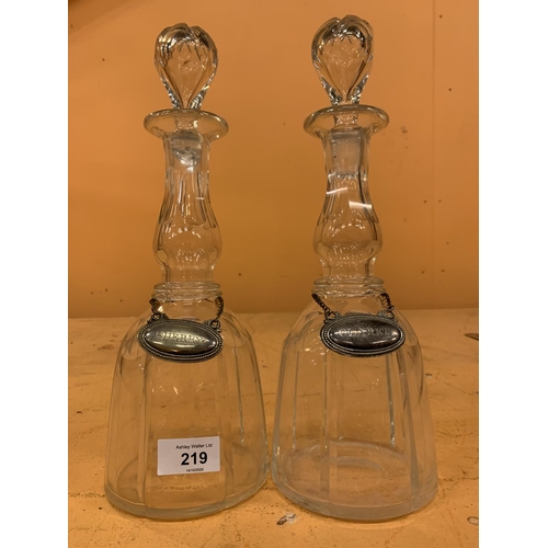 219 - A PAIR OF CUT GLASS DECANTERS WITH SILVER PLATED CLARET AND SHERRY LABELS