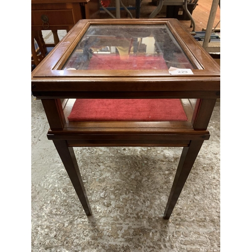 229 - A MAHOGANY FOUR LEGGED DISPLAY CABINET