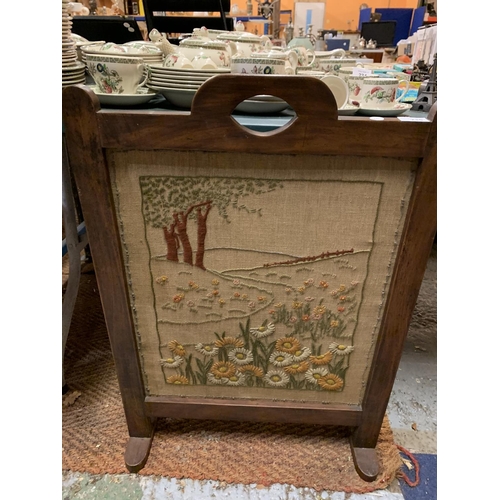 235 - A HAND EMBROIDERED FIRESCREEN ON A WOODEN STAND