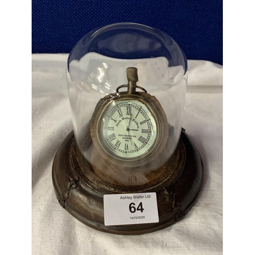 64 - A BRASS POCKET WATCH ON A LEATHER BASE WITH A GLASS DOME