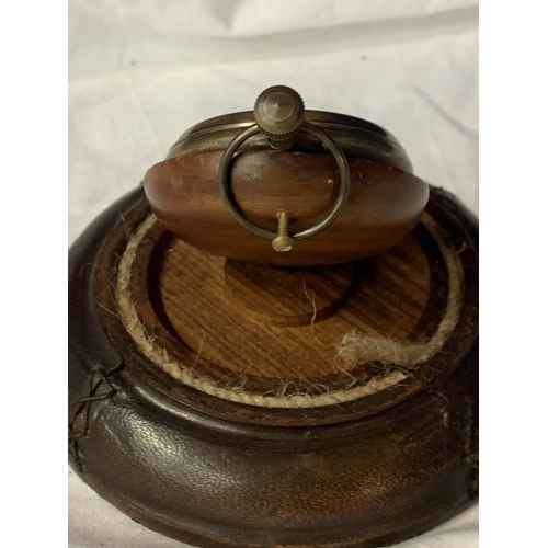 64 - A BRASS POCKET WATCH ON A LEATHER BASE WITH A GLASS DOME