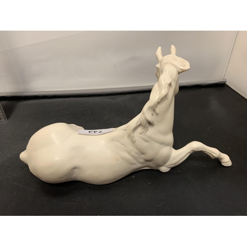 744 - A BESWICK WHITE MODEL OF A HORSE LYING DOWN