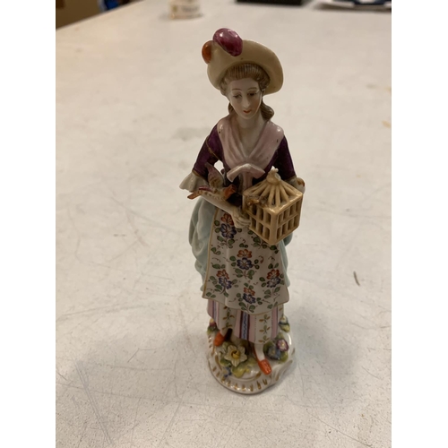 422 - A NINETEENTH CENTURY CONTINENTAL HARD PASTE PORCELAIN FIGURE OF A WOMAN HOLDING A BIRD CAGE