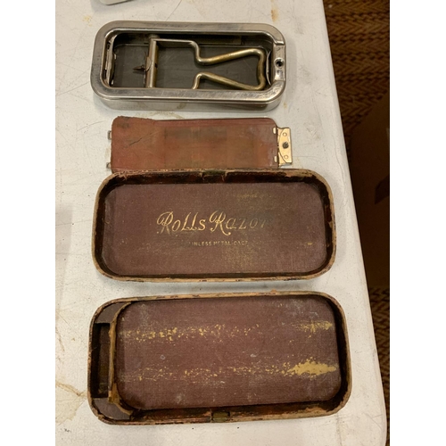 434 - A METAL JEEP TIN CONTAINING SILVER PLATE AND GOLD METAL ITEMS AND A VINTAGE ROLLS RAZOR