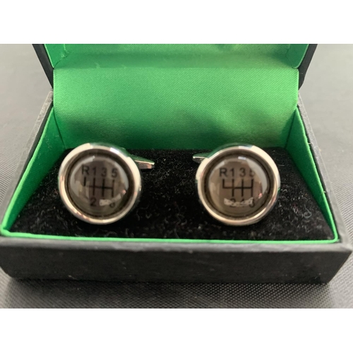 591 - A PAIR OF THOMAS NASH CUFFLINKS IN THE FORM OF A SIX SPEED GEAR KNOB