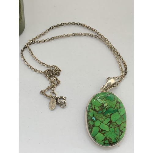 601 - A BOXED STAMPED 925 SILVER MULTI GREEN STONE PENDANT WITH CHAIN