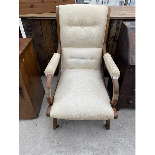 2140 - A 19TH CENTURY OAK FIRESIDE CHAIR ON X FRAME WITH SWEPT BACK AND BRASS CASTERS