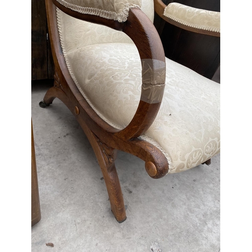 2140 - A 19TH CENTURY OAK FIRESIDE CHAIR ON X FRAME WITH SWEPT BACK AND BRASS CASTERS