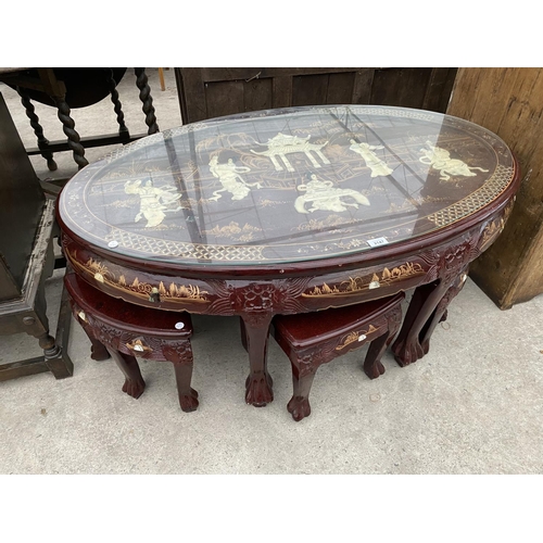 2147 - A CARVED AND DECORATED ORIENTAL STYLE COFFEE TABLE HOUSING A NEST OF SIX MATCHING TABLES